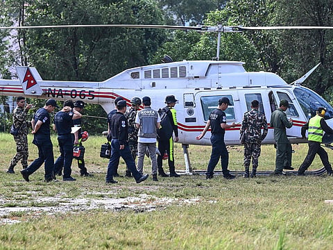 A rescue team leaves to a flooded area in the aftermath of flash floods in Trishuli, Nepal's Nuwakot district.