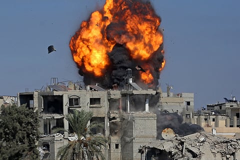 Smoke and fire rise after a house was targeted by an Israeli strike in Khan Yunis, southern Gaza Strip, on September 9.