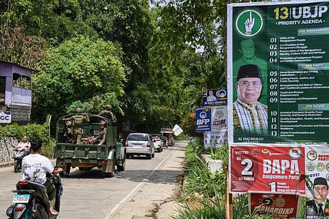 In this photo taken on September 9, 2026, motorists commute past posters of one of the candidates in the Bangsamoro Autonomous Region in Muslim Mindanao (BARMM) election, former Moro Islamic Liberation Front (MILF) chief Murad Ebrahim, in Marawi, Lanao del sur province on the southern island of Mindanao.
