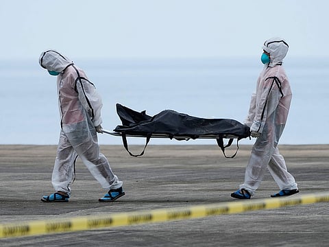 Rescuers carry the remains of victims of the recent fire on the MV June Aster ferry as they arrive on board a Philippine Coast Guard vessel at the Borac port in Coron, Palawan province, western Philippines.