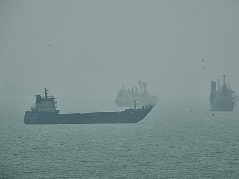 Commercial vessels anchored amid haze in the Strait of Hormuz off Bandar Abbas, Iran