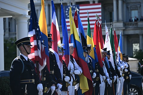 Members of a US military honoUr guard hold flags as they await the arrival of diplomats ahead of an ambassador credentialing ceremony at the White House in Washington, DC, on September 15, 2026.