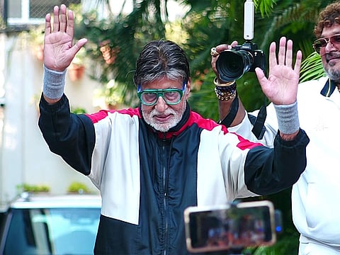 Amitabh Bachchan waves to fans during a public appearance.