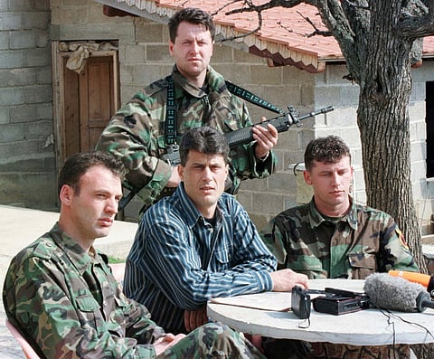 FILE - Hashim Thaci, head of the Kosovo Albanian negotiation team and head of the Kosovo Liberation Army political directorate (centre), addresses a press conference in a secret location in central Kosovo, Saturday, March 13, 1999. (AP Photo/Visar Kryeziu, File)