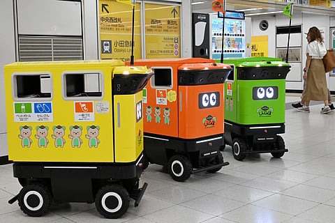 Mobile robotic trash bins are pictured during testing at the Shinjuku Station transport complex in Tokyo