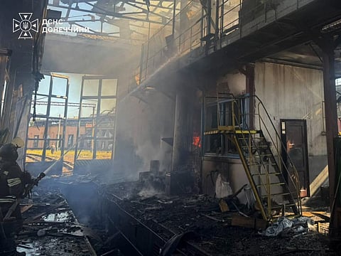 This handout photograph taken and released by the Ukrainian State Emergency Service on September 19, 2026 shows rescuers pushing out a fire in a warehouse damaged following an air strike in Brovary, Kyiv region, amid the Russian attack of Ukraine.