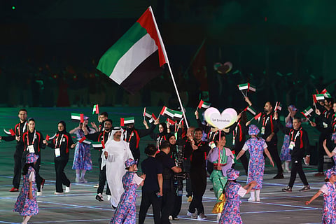 Members of United Arab Emirates' delegation wave their country's national flag during a parade at the opening ceremony of the 2026 Asian Games at Paloma Mizuho Stadium in Nagoya on September 19, 2026.