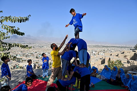 Afghan children attend a circus training session on the rooftop of a house in Kabul on September 21, 2026.