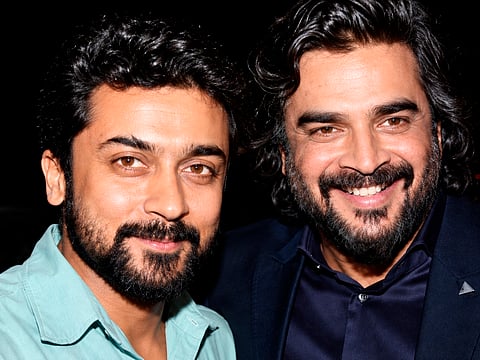 Suriya and R Madhavan share a moment at an event.