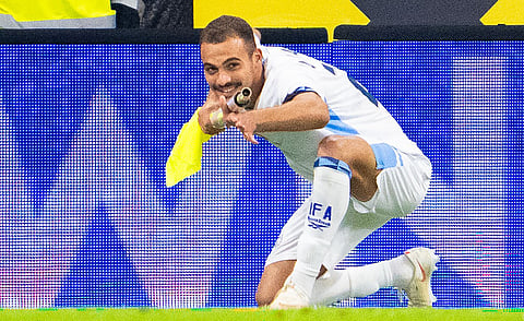 Israel's forward #22 Saied Abu Farchi celebrates scoring his team's first goal while holding a pitch flag pole during the UEFA Nations League Group B3 football match between Austria and Israel in Linz, Austria on September 24, 2026.