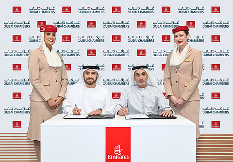 Adnan Kazim, Emirates Deputy President and Chief Commercial Officer and Khalid AlJarwan, Executive Vice President of Commercial and Corporate Services at Dubai Chambers sign an agreement.