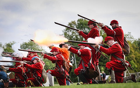 Musketeers of The Marquis of Winchester Regiment fire a salvo from their guns during a battle to re-enact the 1645 English Civil War, at Old Basing House near Basingstoke south east England.