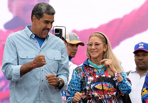 Venezuelan President and presidential candidate Nicolas Maduro (L) dances next to his wife, Cilia Flores, at his campaign closing rally in Caracas, ahead of Sunday's presidential election. File photo taken on July 25, 2024. Maduro and Flores both already face drug trafficking and firearms charges in the US after they were snatched from their Caracas compound in an extraordinary US military raid in January.