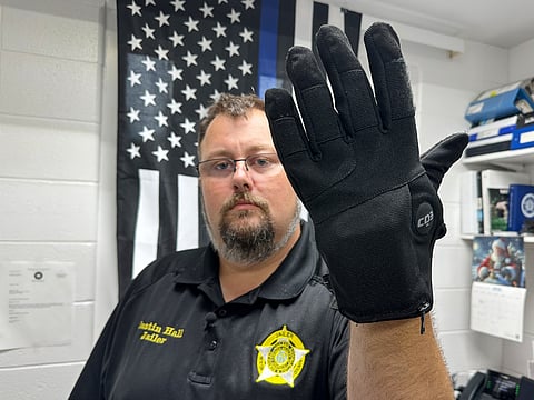 Nelson County, Ky., jailer Justin Hall shows an electric shock glove that is used at his facility, Aug. 13, 2026, in Bardstown, Ky.