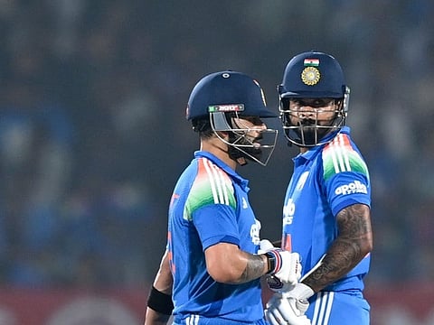 India's Virat Kohli (L) and Shreyas Iyer gesture during the first one-day international (ODI) cricket match between India and New Zealand at the Kotambi Stadium in Vadodara on January 11, 2026.