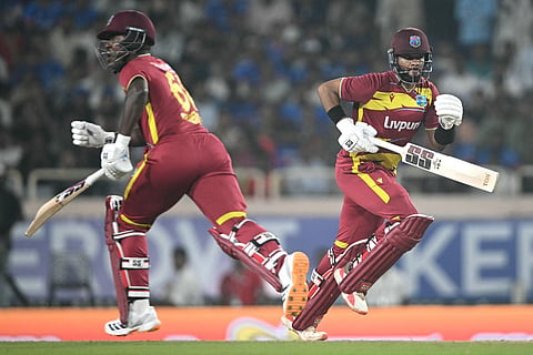West Indies captain Shai Hope (R) and teammate Sherfane Rutherford (L) run between the wickets during the second T20I against India and West Indies at the JSCA International Stadium Complex in Ranchi on October 9, 2026.