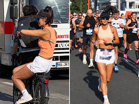 Chinese fitness influencer Yuanyuan Sun is pictured during the Berlin Marathon and riding on a bicycle during the race. She was later disqualified after the incident came to light.