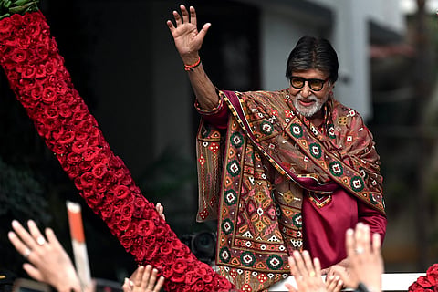 Bollywood actor Amitabh Bachchan gestures to fans gathered to celebrate his 84th birthday outside his residence in Mumbai on October 11, 2026.
