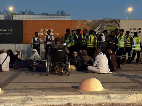People gather outside a metro station on the road to King Khalid International Airport in Riyadh, Saudi Arabia.