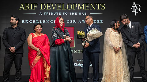 Sheikha Aisha Humaid Al Mulla presents the award to Arif Developments representatives at AES Achievers Summit & Honours 2026