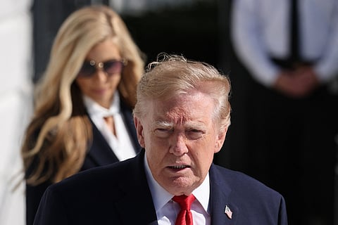 President Donald Trump is followed by White House Press Secretary Katie Zacharia (L) as he departs on the South Lawn of the White House on October 13, 2026 in Washington, DC. President Trump is traveling to Alaska to headline a rally for incumbent Sen.
