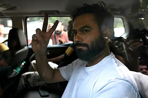 Cockroach Janta Party (CJP) founder Abhijeet Dipke reacts as he leaves after the Special Executive Magistrate ordered him released in New Delhi on October 17, 2026 a day after police detained him amid ongoing protests demanding removal of India's Chief Election Commissioner Gyanesh Kumar over alleged voter roll irregularities linked to the "special intensive revision" (SIR).