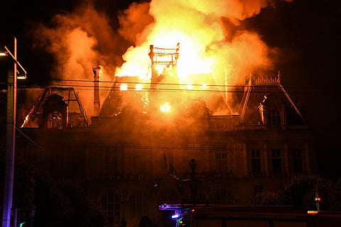 This photograph shows a fire burning and destroying the city hall after a group of individuals forced entry into the building during ongoing protest action against the "high cost of living", in Limoges, central France on October 17, 2026 as part of a nationwide call for mobilisation bringing together various groups expressing their anger: former "Yellow Vest", secondary school and university students, climate activists and even farmers.