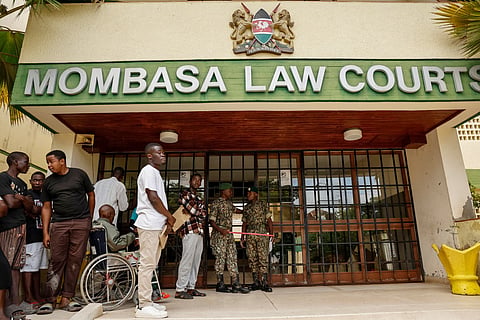 Kenya's national youth service officers stand guard at the entrance to the Mombasa Law Courts where self-proclaimed pastor Paul Mackenzie is scheduled to appear in Mombasa on October 19, 2026.