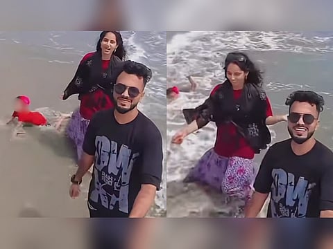 A viral beach video appears to show a toddler struggling in incoming waves while two adults film themselves nearby. A bystander rushes to the child's aid and pulls the toddler away from the water. The footage has sparked debate online over child safety and parental supervision.