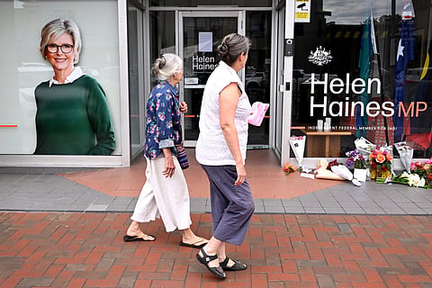 People lay flowers outside the office of Australian politician Helen Haines in the northern regional city of Wangaratta, some 250 kilometres north-east of Melbourne on October 20, 2026.
