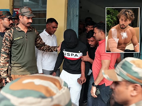 Two of the three accused arrested in connection with the firing incident involving actor Tiger Shroff at the Railway Colony Police Station in Kota on Tuesday, following Mumbai Police’s arrival after a court granted a 48-hour transit remand. Inset: Actor Tiger Shroff with a bandage covering his injuries.