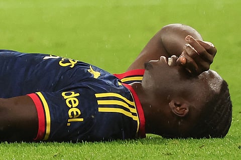 Arsenal's English midfielder #07 Bukayo Saka reacts after sustaining an injury during the UEFA Champions League football match between FC Bayern Munich and Arsenal FC in Munich, southern Germany on October 21, 2026.