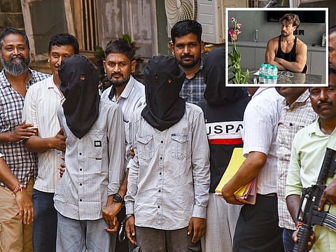 Police personnel escort accused arrested in connection with the firing incident involving Bollywood actor Tiger Shroff in Mumbai. An inset shows Tiger Shroff.