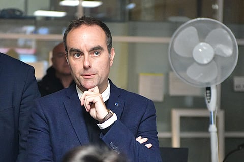 France's Prime Minister Sebastien Lecornu (C) reacts at a police station during a visit to Limoges in the context of security and reconstruction efforts after a group of individuals forced entry into the town hall building during last weekend's protest action against the "high cost of living" in Limoges on October 23, 2026.