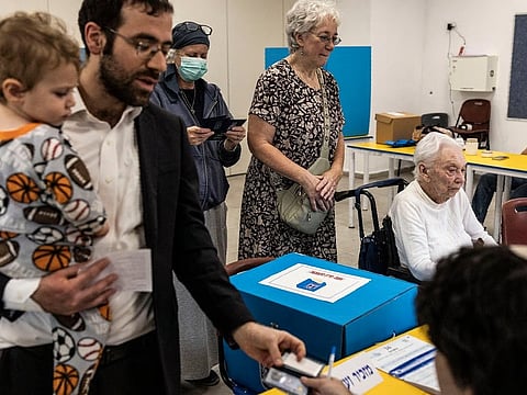Voters register at a polling station inside the Ziv community center in Jerusalem on October 27, 2026 during Israel's legislative election.