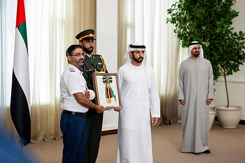 Sheikh Hamdan bin Mohamed Al Maktoum, Crown Prince of Dubai, UAE Deputy Prime Minister and Minister of Defence presents the First Class Order of Zayed II to a member of flydubai crew.