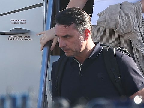 Flavio Bolsonaro steps off a plane after arriving at Opa Locka Executive Airport in Miami, Florida.