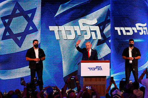 Israel's Prime Minister Benjamin Netanyahu waves to his supporters at the election night rally after the first exit polls were announced, in Jerusalem on early October 28, 2026, during Israel's legislative elections.