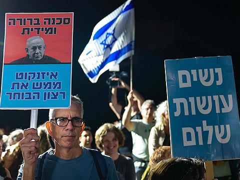 Israeli left-wing activists hold placards during a demonstration outside the home of Gadi Eisenkot, leader of the Yashar party, in Herzliya on October 29, 2026, calling for the formation of a government that includes Arab parties.