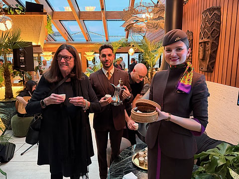 Marilyn Bell from Tourism Calgary (left) enjoys Arabic coffee and dates at the reception hosted by Etihad Airways in Calgary to celebrate launching of Abu Dhabi-Calgary direct flight.