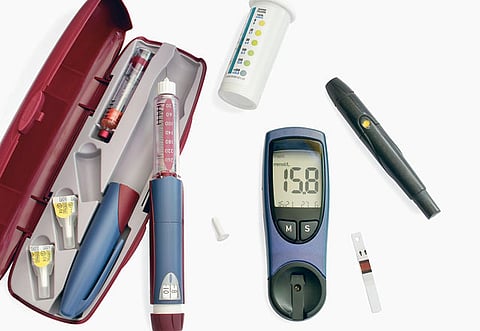 Blood glucose meter, insulin pen, test strip, lancing device. Photo for illustrative purposes