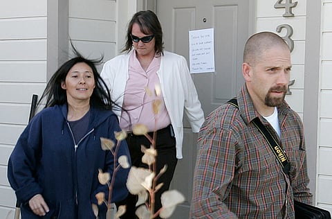 Mayumi Heene (left) leaves her home escorted by Larimer County Sheriffs in Fort Collins, Colorado. She and her husband Richard have been pardoned for the “balloon boy” hoax, which became a worldwide media sensation.