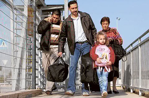 In this file picture, a Palestinian Christian family from Gaza enters Israel through the Erez border crossing between Israel and northern Gaza Strip on Thursday.