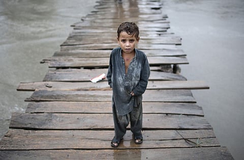 A child walks on a wooden bridge towards the village of Shah Alam on the outskirts of Peshawar in Pakistan (File)