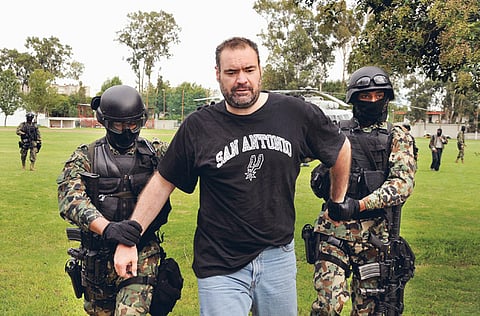 Mexican marines escort Sergio Villarreal Barragan after he was captured on the outskirts of Puebla o