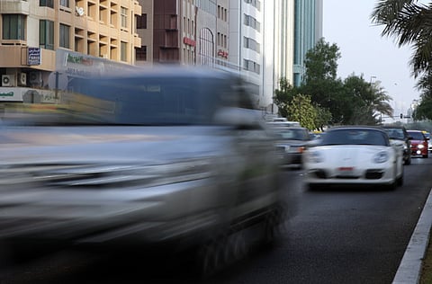 A car speeds past on an Abu Dhabi road.
