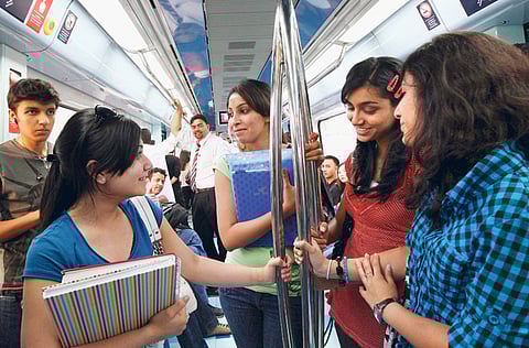 A multi-cultural mix of passengers aboard the Dubai Metro.