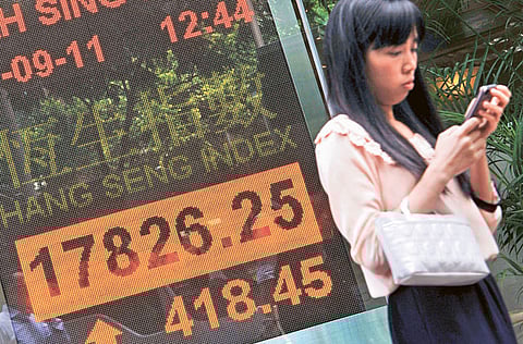 A display board showing Hong Kong’s Hang Seng stock market index. Asian tech shares haven't been immune from the global selloff in speculative assets, but investors are sifting through the ashes and some see buying opportunities.