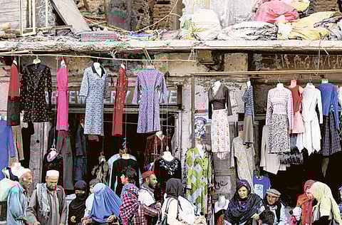 Pedestrians walk past goods for sale at a market in Kabul. Afghanistan is facing the heightened risk of a financial collapse after being propped up for the past two decades by foreign aid.