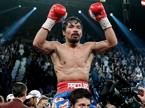 Manny Pacquiao celebrates after his victory over Juan Manuel Marquez during a WBO welterweight title fight in Las Vegas.